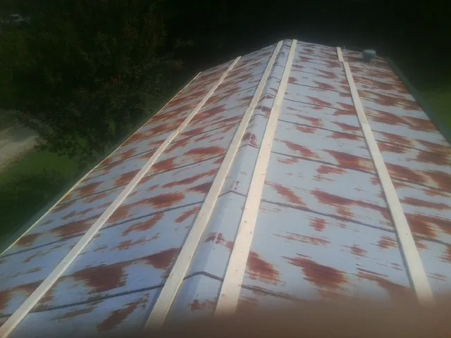 Rusted metal roof panels with new wood purlins before replacement — Storm Damage Roof Repair in Scott Bar by Roofing Brothers