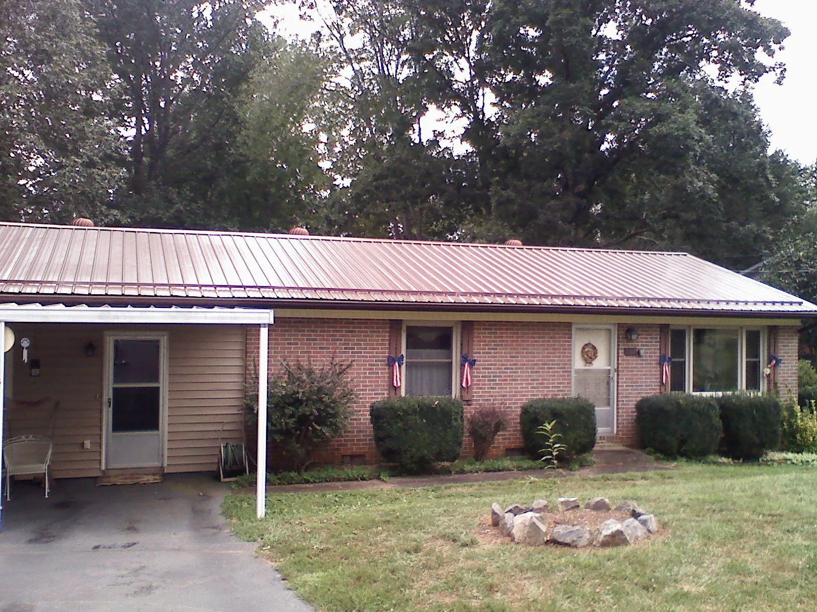 Bronze metal roof and carport on a brick ranch home — Roof Repair work by our crew in Scott Bar